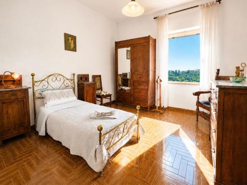 a bedroom with a bed and a large window at Casa di Nonna in Montefranco