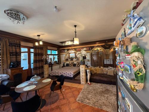 a living room with a bed and a refrigerator at Villa Éden in Siófok