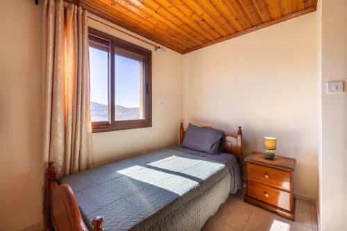 a bedroom with a bed and a window at All Saints Retreat in Koilani