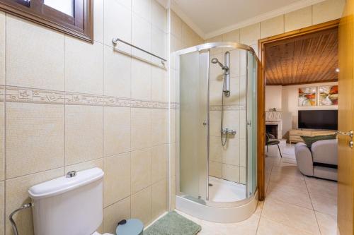 a bathroom with a shower and a toilet at All Saints Retreat in Koilani
