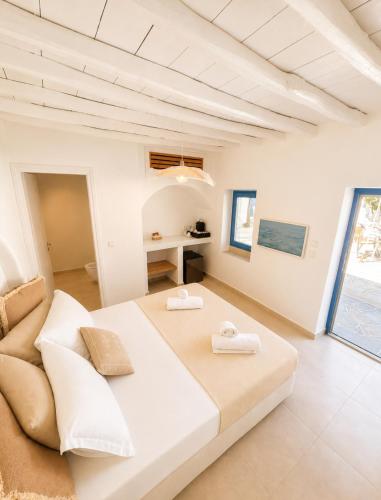 a bedroom with a large bed and a couch at Lodge Narlis in Platis Gialos