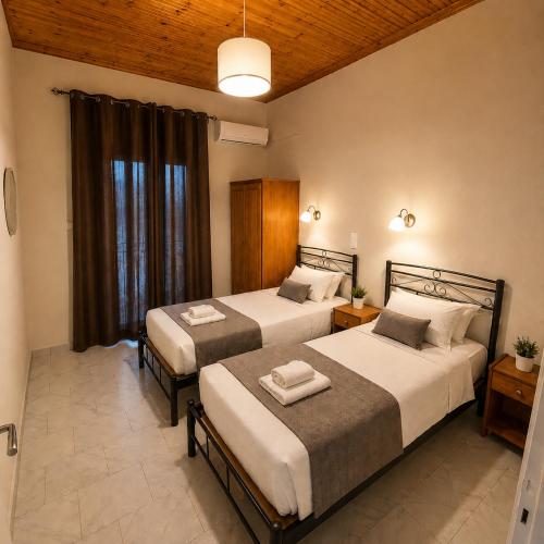 a bedroom with two beds and a window at Villa Yannis 1 in Roda