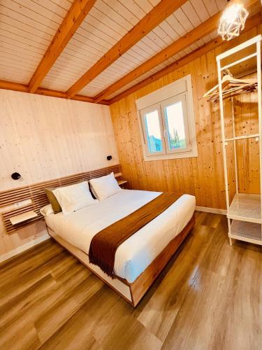 a bedroom with a bed in a wooden room at Casa Ana & Spa in Conil de la Frontera