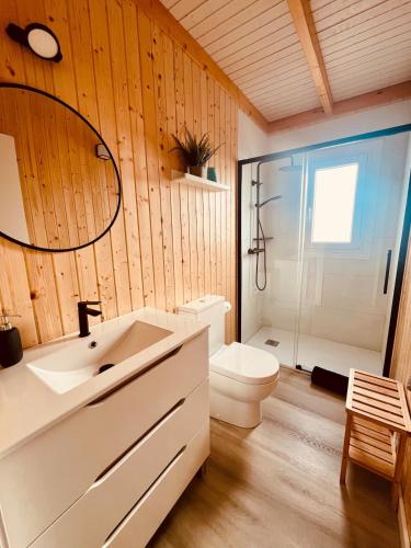 a bathroom with a white sink and a toilet at Casa Ana & Spa in Conil de la Frontera