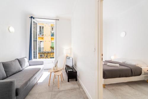 a living room with a couch and a bed and a mirror at Meilleur emplacement de Nice Charming Flat #3 in La Celle-sous-Gouzon