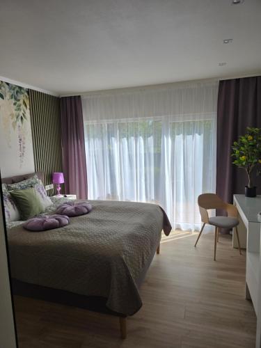 a bedroom with a bed with pillows on it at APARTAMENTI BrivdienuKolka in Kolka