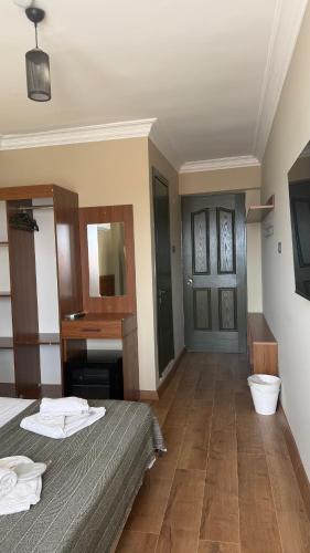 a hotel room with a bed and a sink at cunda panorama otel in Ayvalık
