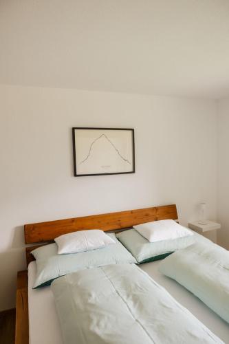 two beds in a room with a picture on the wall at Haus Hermann in Schruns