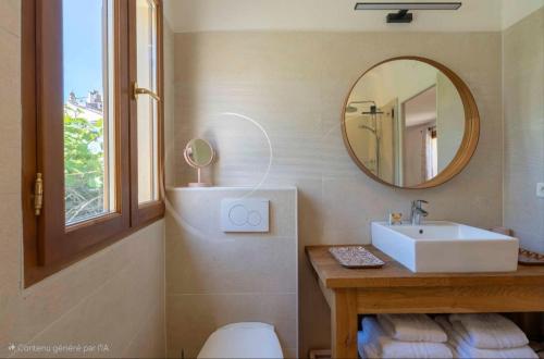 a bathroom with a sink and a mirror at Maison Magdeleine in Saint-Tropez