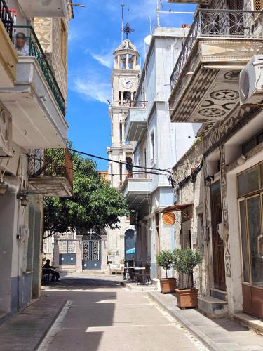 a city street with a clock tower in the distance at Mastiha Essence Residence in Pyrgi