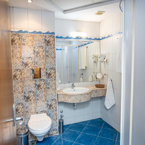 a bathroom with a toilet and a sink at Hotel Premier - Veliko Tarnovo City Center, Panorama View in Veliko Tŭrnovo