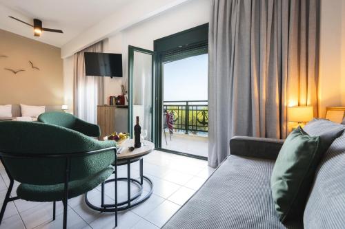 a hotel room with a couch and a table and chairs at By Captains Studio in Ierapetra