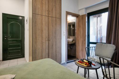 a room with a bed and a table with a bowl of fruit at By Captains Studio in Ierapetra