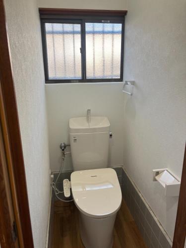 a bathroom with a toilet with a window above it at Seaside accommodation - Vacation STAY 22044 in Horiechō