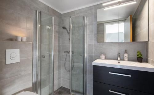 a bathroom with a shower and a sink and a toilet at Modern apartment with amazing location in Hol