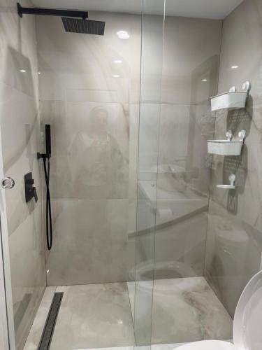 a shower with a glass door in a bathroom at 2BDRM-Kitchenette-BBQ-Smart TV-4-5Guest in West Vancouver