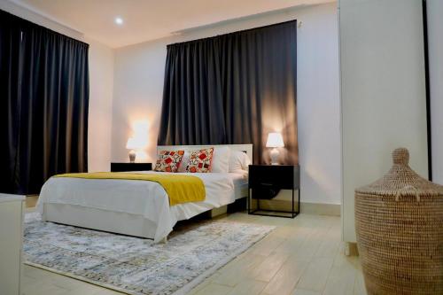 a bedroom with a bed and a large window at Sea view beach apartment in Bijilo
