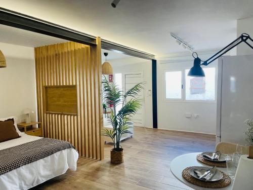 a bedroom with a bed and a plant in it at Casa Señora Reyes in Famara