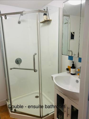 a bathroom with a shower and a sink at Nicole Guest House - Private Room & Bathroom - 6kms from City in Brisbane