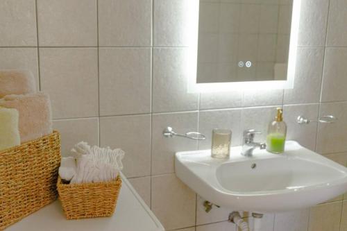 a bathroom with a sink and a mirror at SunKipos in Paleros