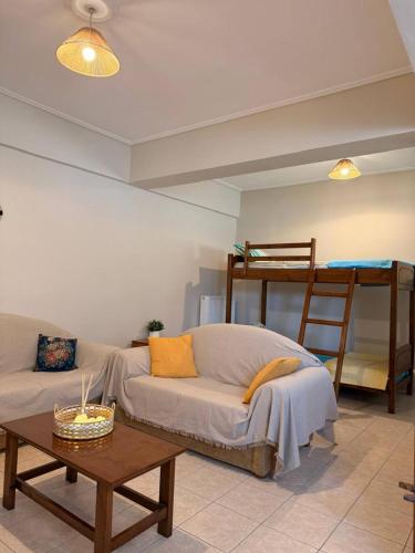 a living room with a couch and a bunk bed at SunKipos in Paleros