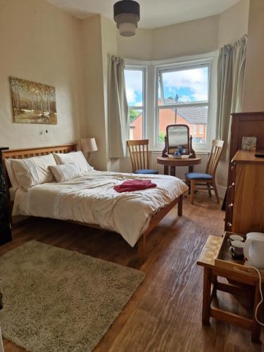 a bedroom with a bed and a desk and a window at The Boughton Peterchurch - Pub Grub & Bed in Peterchurch