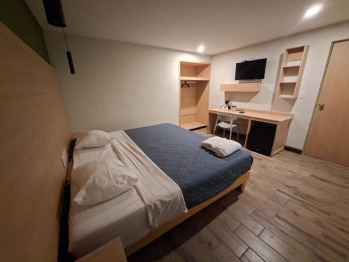 a small bedroom with a bed and a desk at Hotel casa el Palomar - 3 in San Baltasar