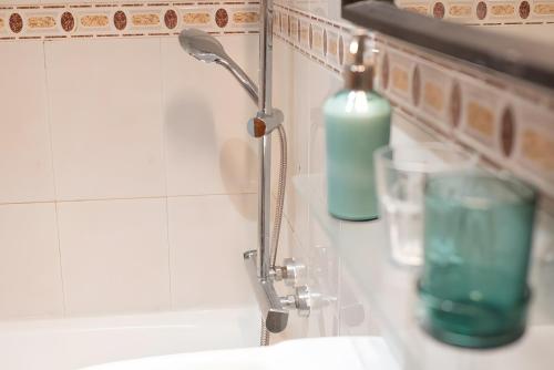 a bathroom sink with a faucet and a bottle of soap at Casa para descubrir el mar in La Garita