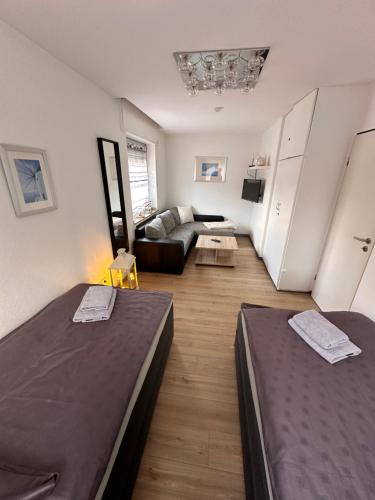a living room with two beds and a couch at Haus-36 in Neuss