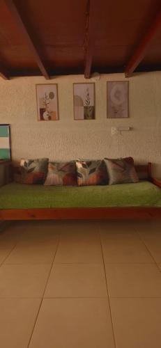 a bench with pillows on it in a room at Bem Me Quer - Hospedagem in Trindade
