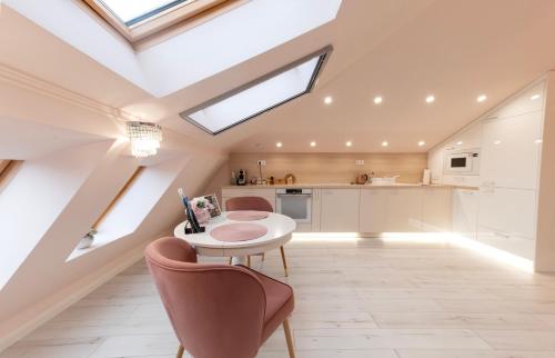 a kitchen with a skylight and a table and chairs at Harmony Boutique Villa in Siófok