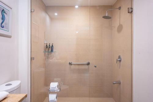 a bathroom with a shower with a toilet and a sink at Jaco Bay 1202 in Jacó