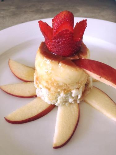 a dessert with a strawberry on a white plate at Las Eduardas in La Paloma