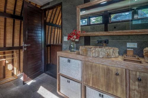 a bathroom with a wooden sink and a mirror at 4 Elements - Contadora Island in Contadora