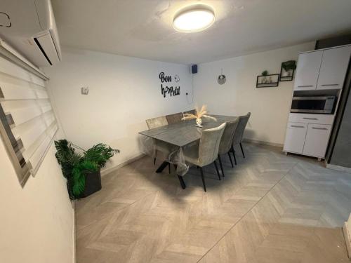 a dining room with a table and a kitchen at SeaSide Villa in Ashdod