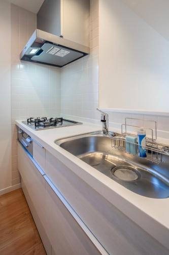 a kitchen with a sink and a stove at treehouse - Vacation STAY 22128 in Nagoki