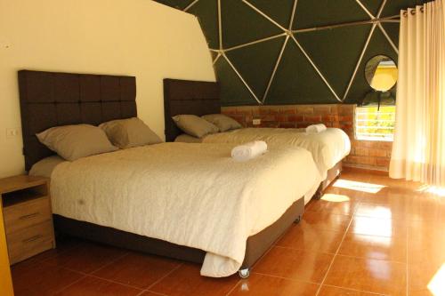 a bedroom with a bed with two pillows on it at Sky Domos Pachar in Pachar