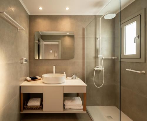 a bathroom with a sink and a shower at Pefki Luxury Suites in Telendos