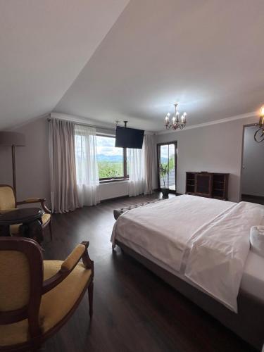 a large bedroom with a large bed and a tv at Crai Stone House in Bran