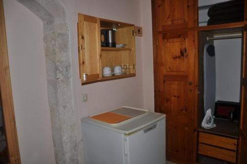 a kitchen with a small white refrigerator in a room at Pension Castello in Rethymno