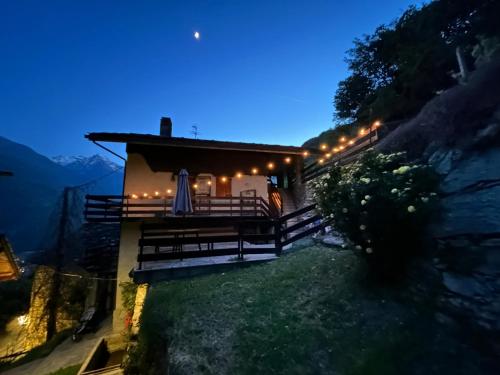 a house with lights on the side of it at night at Casa Vanda in Châtillon
