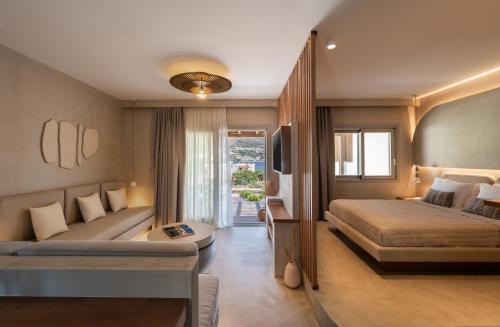 a hotel room with two beds and a couch at Pefki Luxury Suites in Telendos