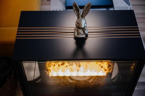 a statue of a rabbit sitting on top of a table at Apartmány Esprit in Dolný Kubín