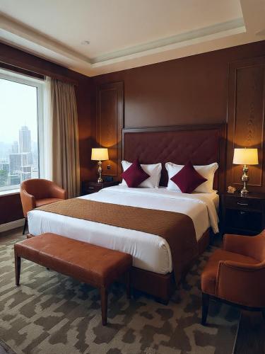 a hotel room with a large bed and a window at Hotel Grand Marina Near IGI Airport Delhi in Bichpuri