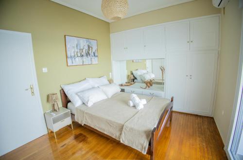 a bedroom with a large bed with white pillows at Blue Horizon Seafront Apartment in Agioi Theodoroi