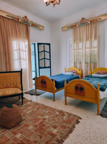 a bedroom with three beds and a couch at Morjana Castle in Sousse