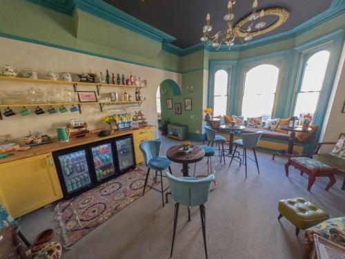 a living room with a video game room with a table and chairs at The Sheldon B&B in Eastbourne