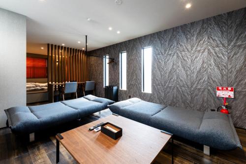 a living room with blue couches and a table at 2F, 3F - Vacation STAY 20122v in Sumiyoshi