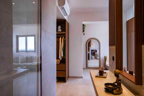a bathroom with a sink and a mirror at Kastri Beach Suites in Faliraki