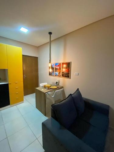 a living room with a couch and a table at zaiflats outono in Vitória de Santo Antão